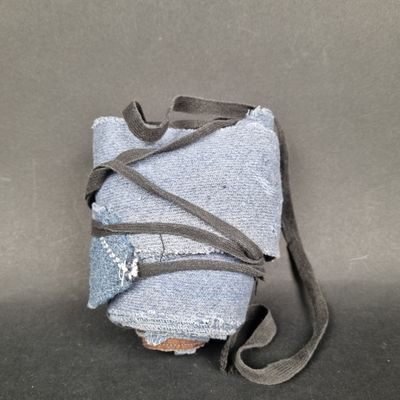 a bag with a strap wrapped around it sitting on a table
