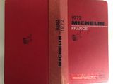 two red books sitting on top of each other on a table