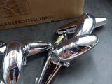 two chrome faucets sitting on a counter next to a box
