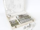 a box with silverware in it on a white surface