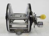 an image of a metal reel with a yellow handle