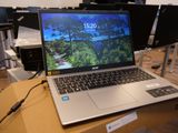 a laptop computer sitting on top of a box on a table