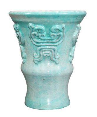 a blue vase with a decorative design on the outside of it