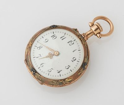 a gold pocket watch with a white face on a white surface