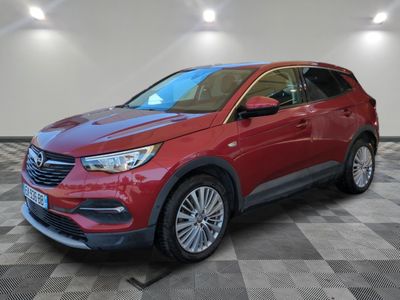 a red buick suv parked on a checkered tile floor