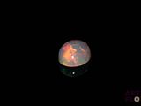 an image of a white fire opal in the dark