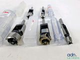 four different types of drill heads on a white surface