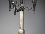 a silver candelab with three candles on it