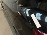 a black car with a black seat belt and a black seat cover