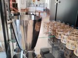 a display case with cups and a large silver bowl