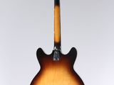 a close up of a guitar hanging from a string