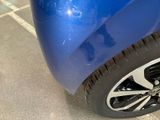 a close up of a blue car with black rims