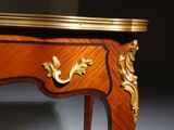 a wooden table with a gold decoration on it