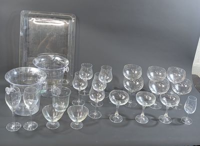 a lot of wine glasses and a tray on the table