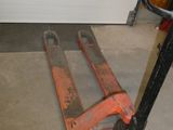 an image of a fork lifter in a garage