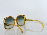 yellow and green sunglasses on a white surface with a white background