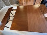 a wooden table and two benches in a room