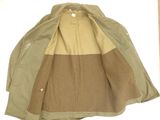 beige and green jacket with a brown and tan color block on the back