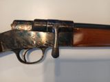 a close up of a rifle on a wall with a white background