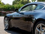 a black sports car parked in a parking lot