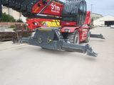 a large crane that is sitting on the side of the road