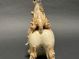 a figurine of a horse with a hat on its head