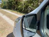 a white car that is parked on the side of the road
