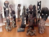 a lot of african statues on display on a table