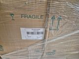 a box with a fragile label on it wrapped in plastic