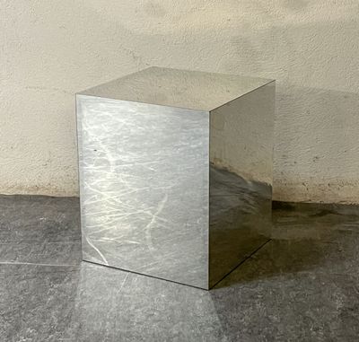 a silver box sitting on the floor in front of a wall