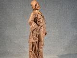 an old statue of a man holding a child in his arms