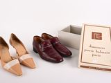 two pairs of shoes that are next to a box