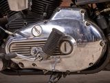 a close up view of a motorcycle engine with a clock on it