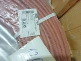 a large roll of pink electrical wire wrapped in plastic
