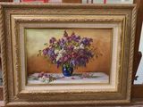 a painting of purple and white flowers in a blue vase on a table