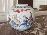 a white vase with a painting on it sitting on a table