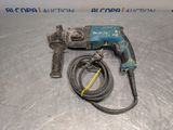 a close up of a drill on a table with a hose
