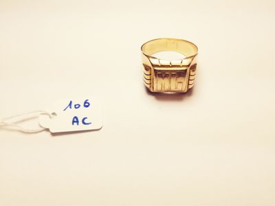a gold ring with a price tag attached to it