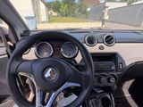 someone is sitting in the driver ' s seat of a car with their feet on the steering wheel