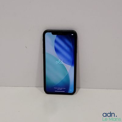 the back of a black phone sitting on top of a white table