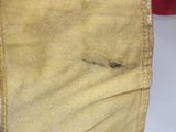 a close up of a pair of jeans with a small patch in the pocket