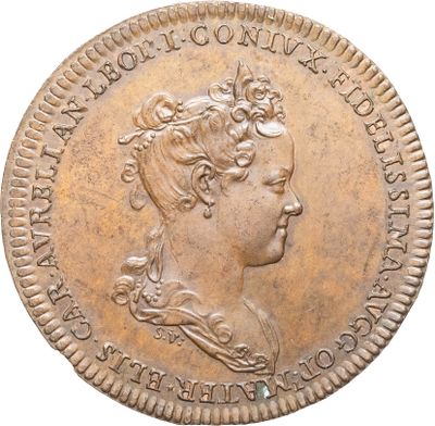 gros plan d'une pièce de monnaie sur laquelle figure une tête de femme