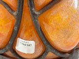 a vase that has a bunch of oranges inside of it