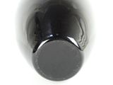 a close up view of a wine bottle on a white surface