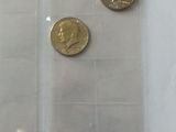 five coins in a clear plastic bag on a table