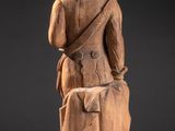 an image of a statue of a man sitting on a chair