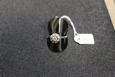 a close up of a ring on a black surface with a price tag