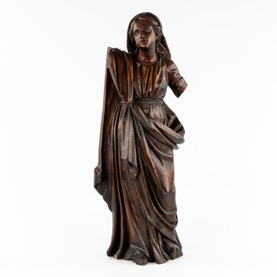 a bronze statue of a woman in a dress