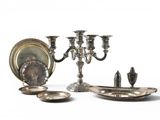 a silver plate with a candelab and a silver plate with a candelab and a silver plate with a candelab and a silver plate