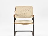 the back of a chair with a seat made out of wood and fabric